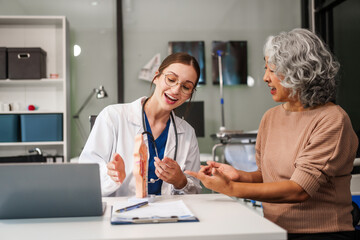 Caucasian woman and elderly Asian woman discuss health issues cold, influenza, pneumonia, bronchitis, stomach disease, GERD, IBS, inflammatory bowel disease, gallstones, chronic constipation