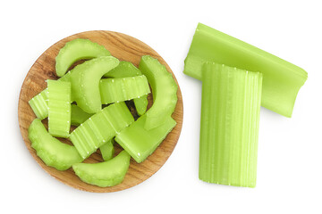 fresh celery in wooden bowl isolated on white background. Top view. Flat lay