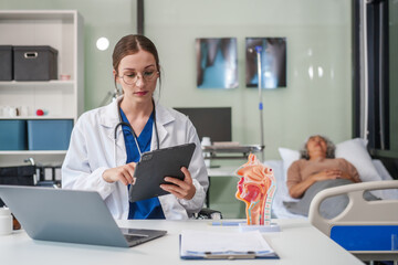 A female Caucasian specialist doctor sits at her desk, specializing in gastrointestinal and liver...