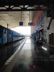 Low-angle image of a train on tracks in a small hallway.