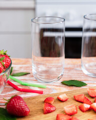Empty glasses on the table in the kitchen for strawberry lemonade. Making lemonade with strawberries. Selective focus.
