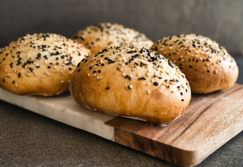 Freshly Baked Sesame Seed Buns on Board
