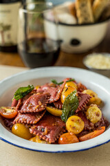 Beet ravioli with cherry tomatoes and basil ready to eat