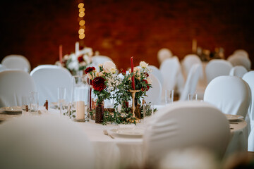 Valmiera, Latvia - August 19, 2023 - A warmly lit wedding reception hall with decorated tables,...