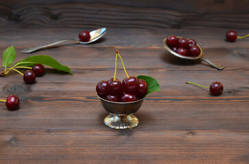still life with ripe cherries in a rustic style - obrazy, fototapety, plakaty