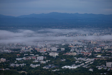 High-angle view of the city with mist passing through. Many buildings in Chiang Mai, Thailand