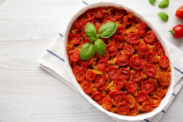 Homemade Easy Tomato Basil Pasta Bake, overhead view. From above, flat lay, top view. Copy space.