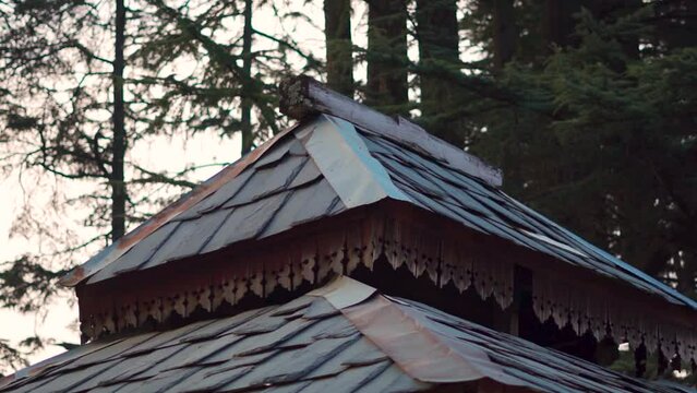 Closeup shot of traditional slate roof of the Shangchul Mahadev Temple besides the meadows of Shangarh at Sainj Valley in Himachal Pradesh, India. Temple made in traditional Himachali Kath kuni style.