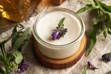 Comfrey root ointment in a glass jar