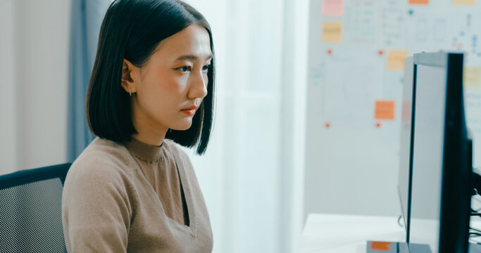 Young adult Asia female freelance typing write prompt AI bot IT app smart program nomad, video game, terminal with coding language, user interface, designer, big data center on desktop computer.