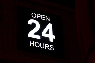 Open 24 Hour neon sign in the street.