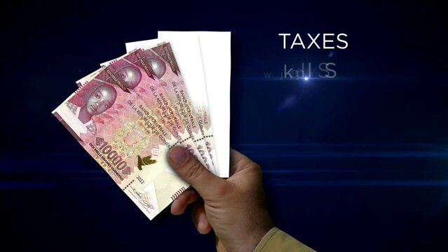 Guinea Franc money holding. Fan of banknotes in hand. Guinean GNF paper cash. Concept of income, success, business, tax, economy and finance.