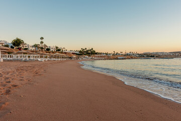 Summer background with tropical beach during sunset. Holiday vacation and travel concept.