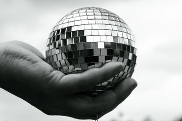 Cropped hand holding a disco ball