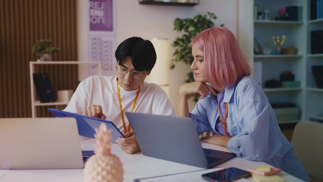 Multiracial web designers discussing new project, creating company logo, team