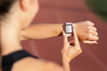 Woman looking at her smartwatch, blank touchscreen