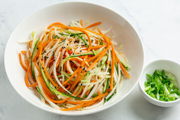 fresh and healthy cucumber, carrot and daikon radish salad