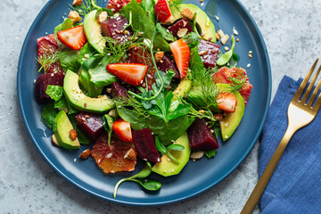 Fresh healthy avocado, strawberry,  blood orange and  beetroot salad