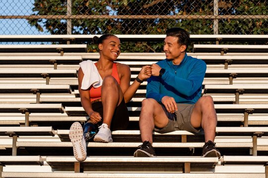 Woman and man workout buddies doing fist bump