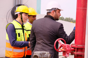 Engineers check fire extinguishing system valves in buildings and industrial plants.