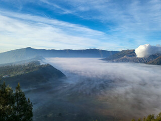 The clear sky is beautiful and blue with Mount Bromo still emitting volcanic smoke side by side with Mount Batok. The Sea of Sand plains began to appear because the fog began to disappear slowly
