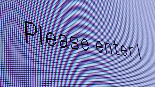 ディスプレイモニターに映し出される「Please enter」の文字クローズアップ。