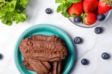 Chocolate shortbread cookies. Light background.