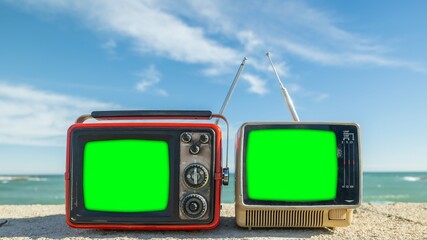 televisions with green screen next to the sea, to add your own content onto the tvs - 801244685