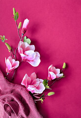 Elegant Magnolia Flowers on Vibrant Pink Background with Textured Fabric.