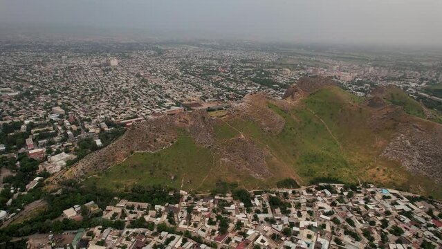 Aerial view of Sulaiman Too Sacred Mountain in Osh city, Kyrgyzstan. The symbol of the city of Osh. Beautiful powerful mountain