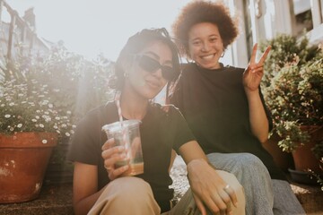 Two friends sitting and talking while having a coffee