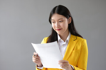 Real estate agent presenting residential building and house sale contract to sign. Businesswoman in office working with house and land sales contract documents.