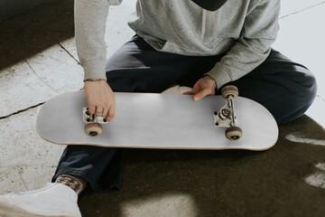 Man tighten white skateboard trucks