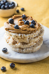Peanut butter and rice cakes sandwich. Healthy protein snack.
