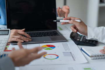 close-up hands image, Professional Asian male and female financial consultant or analyst working with them team, brainstorming and analyzing financial data on the report together in the office