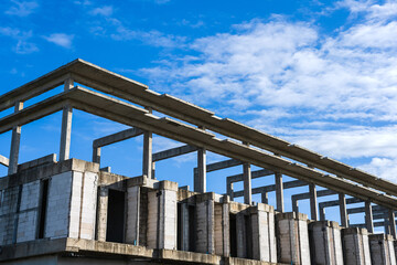 Unfinished building in housing project with blue shy