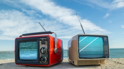 televisions with glitch next to the sea