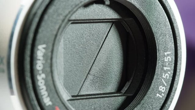 Close-up of Vintage video-camera. Close and open lens zoom of camera. Using portable camcorder to shooting videos