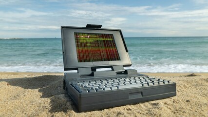 laptop computer on a beach with data and code on screen - 801273811