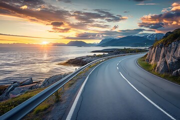 A beautiful road along the sea in Norway, with an ocean view and mountains on both sides. The sun sets behind them, casting warm hues across the sky