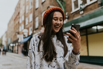 Fototapeta premium Woman having a video call in city