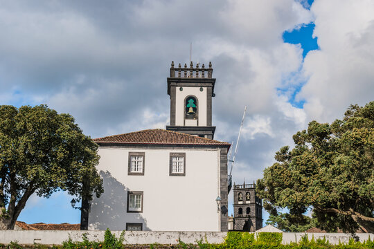Building of city hall of Ribeira Grande will bell tower and another of church in background, São Miguel - Azores PORTUGAL