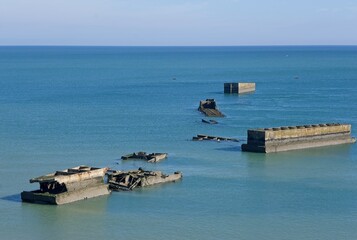 Tracy-sur-Mer, France - Apr 29, 2024: What remain of Arromanches artificial port (Mulberry B)...