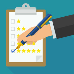 A hand with a pen ticks a rating with stars placed on a clipboard in flat design style