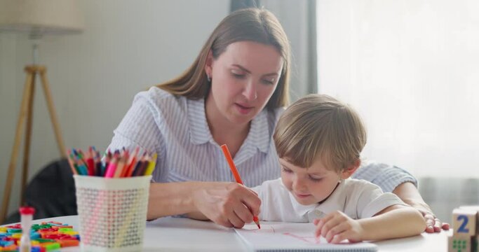 Mother Teaching Son Drawing at Home
