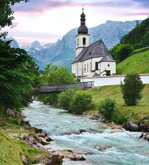 Mountain landscape in the Bavarian Alps and famous Parish Church of St. Sebastian in the village of...