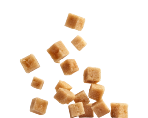 Falling brown sugar cubes on transparent background