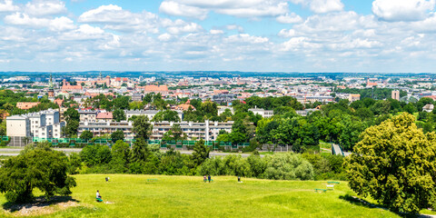 View of Kraków, Poland, seen from Krakus Mound. On a warm summer day like this, the blue sky and light clouds above adds to the beauty of the scenery.