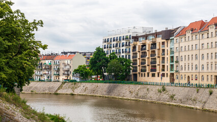 The Oder River runs straight through Wrocław, Poland. A mix of older and newer apartment buildings...
