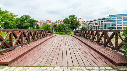 Old wooden pedestrian and bicycle bridge in the central part of Wrocław, Poland. A big contrast to...